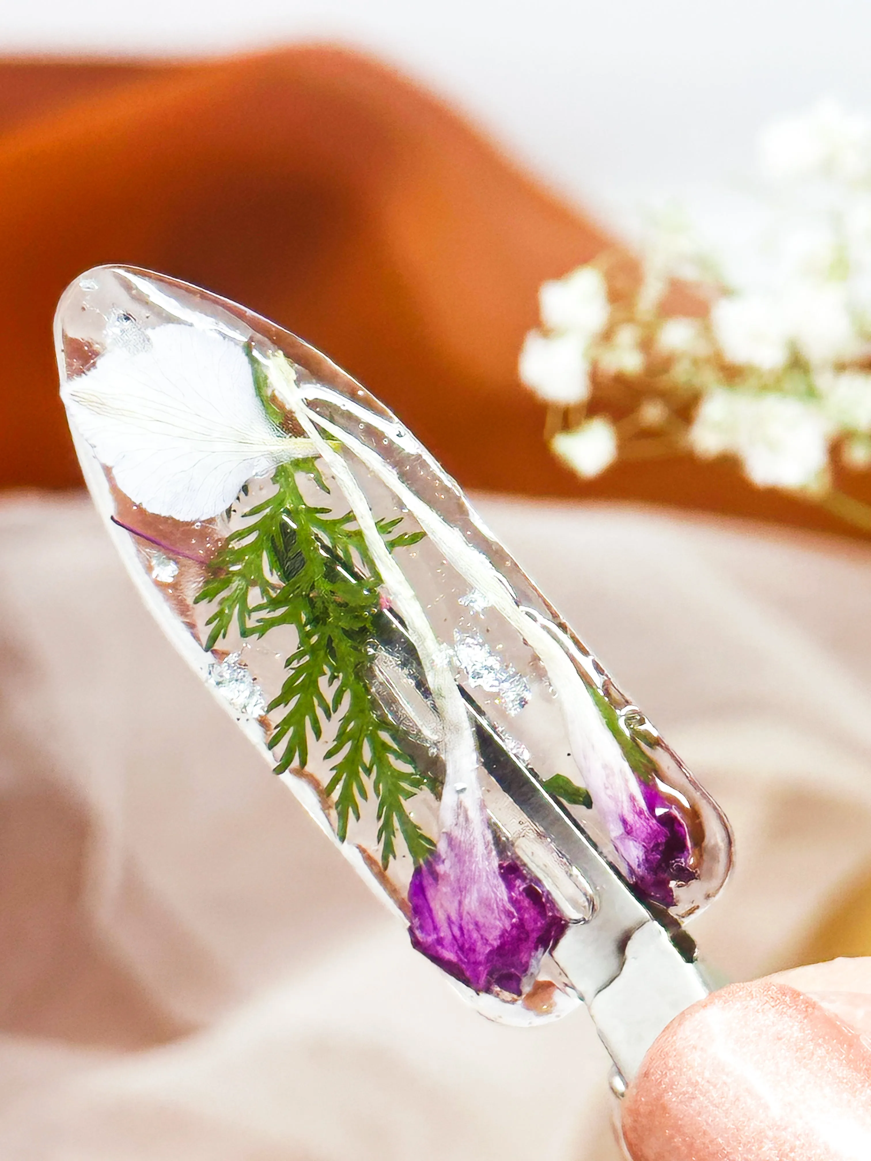 Clear No dent resin clip with Real White and Pink Toned Flowers and Greenery Cast Inside.
